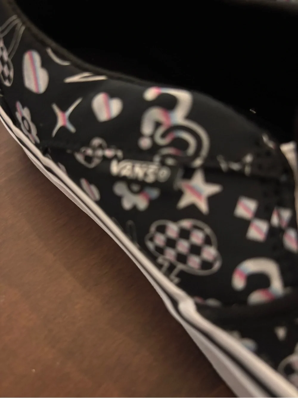 Vans Women’s Black Slip-On Sneakers with Multicolor Icon Accents